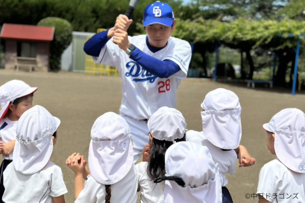 中日ドラゴンズの選手が子供たちにバットの振り方を教える様子